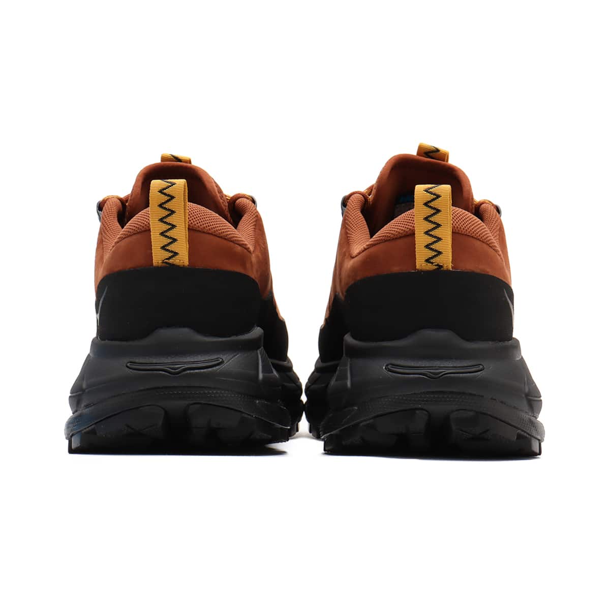 Hoka Tor Summit hiking shoes with nubuck leather, rubber mudguard, and metal eyelets, blending alpine boot design with urban style for enhanced durability and comfort.