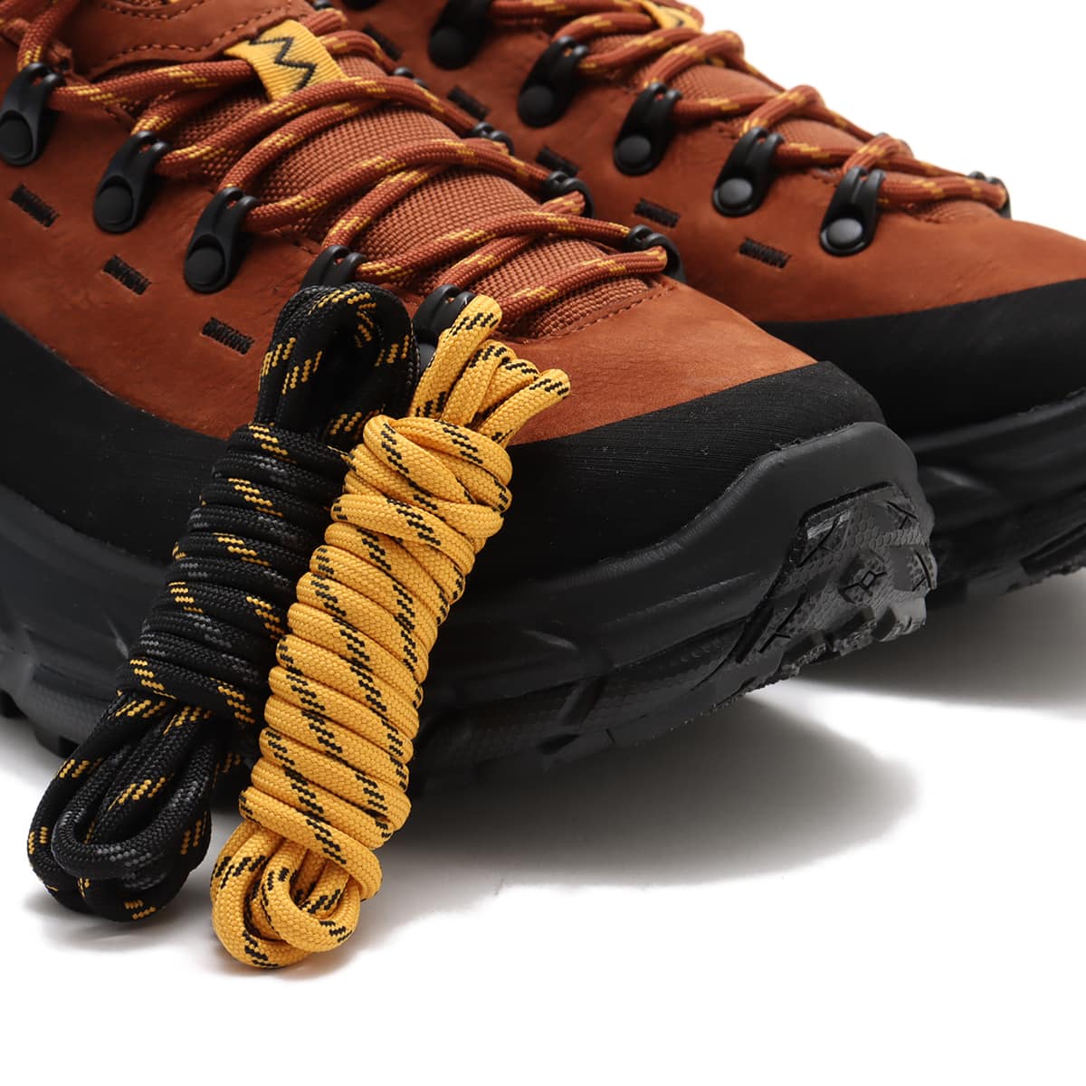 Hoka Tor Summit hiking shoes with nubuck leather, rubber mudguard, and metal eyelets, blending alpine boot design with urban style for enhanced durability and comfort.