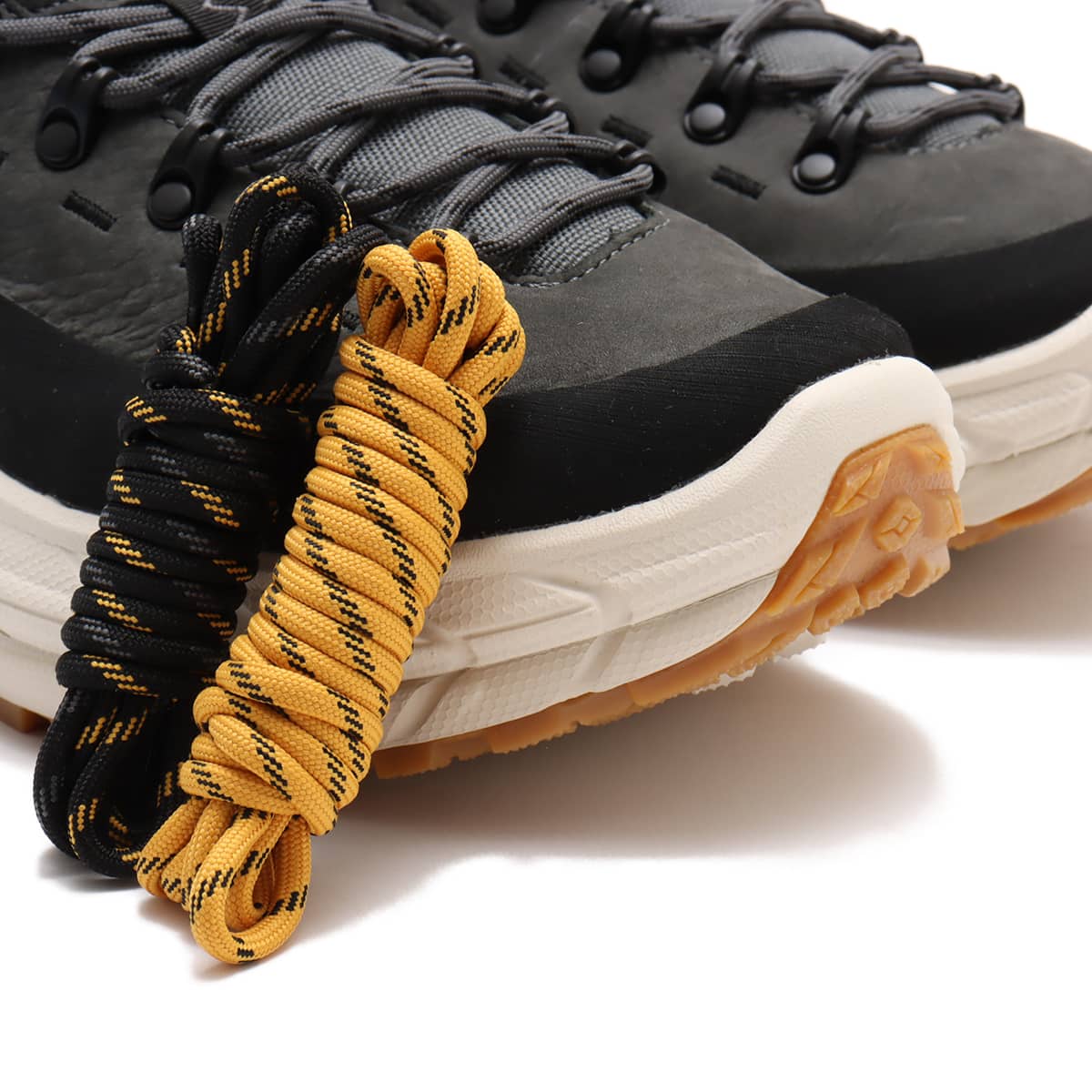 Hoka Tor Summit hiking shoes with nubuck leather, rubber mudguard, and metal eyelets, blending alpine boot design with urban style for enhanced durability and comfort.