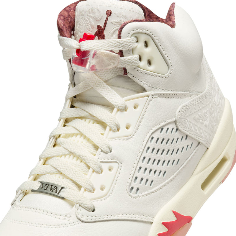 Exclusive AJ5 sneakers celebrating Mexico's heritage, featuring laser-cut leather, embossed patterns, asymmetrical midsole flames, off-white leather, and red and green lace locks, with a "VIVA" dubrae.


