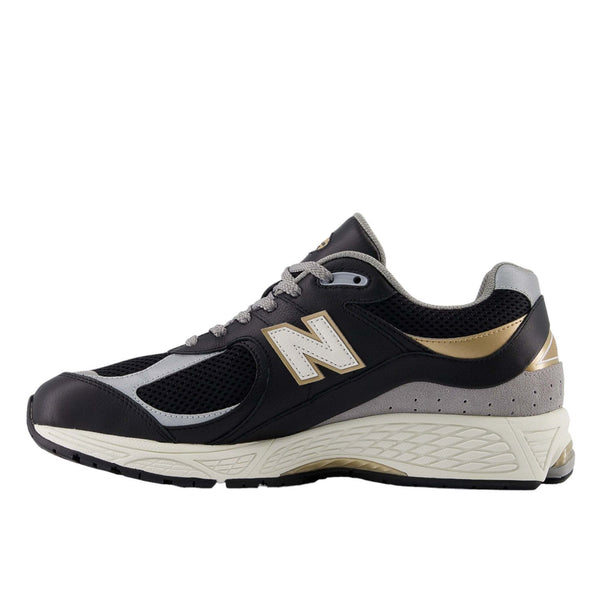 New Balance M2002RPO sneakers with leather upper, black, sea salt, and metallic gold details, offering premium comfort and durability.