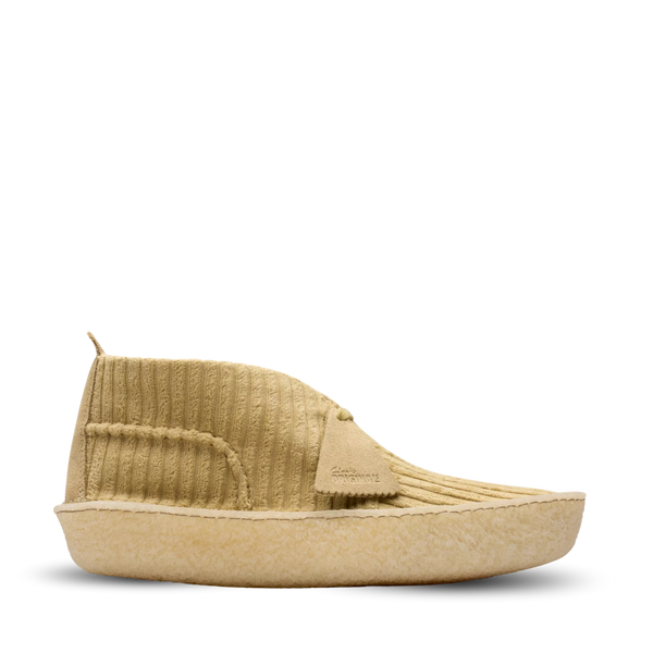 Clarks Originals shoe with premium maple cord upper, round tonal laces, metallic logo, and natural crepe sole wrapping heel and toe.