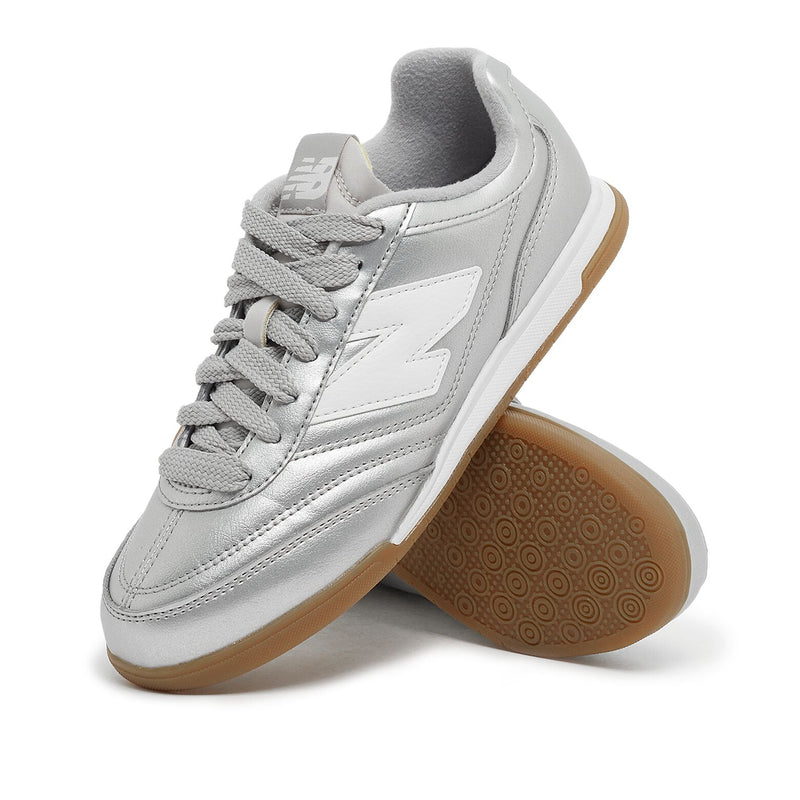 New Balance Wmns URC42CA sneaker with silver metallic leather upper, contrasting N logo, EVA cushioning, and breathable mesh lining for comfort and style.