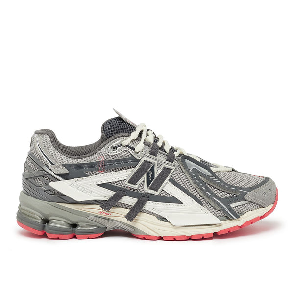 New Balance U1906AA sneaker with grey mesh upper, beige and brown overlays, NLock Lacing system, and cushioned sole with N-Ergy and ABZORB SBS pods.