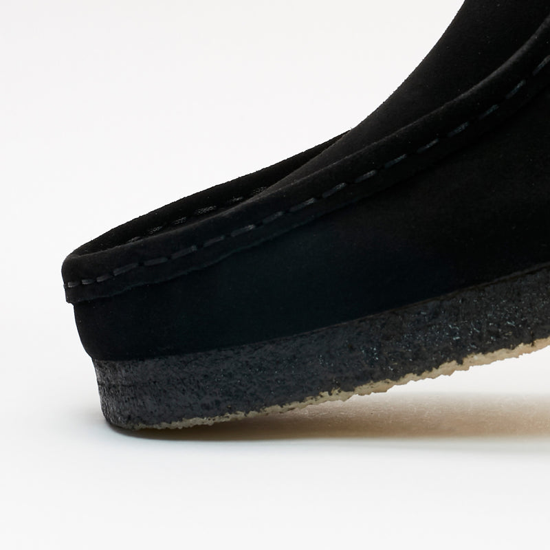 Clarks Wallabee in black suede with a structured moccasin design and signature crepe sole.


