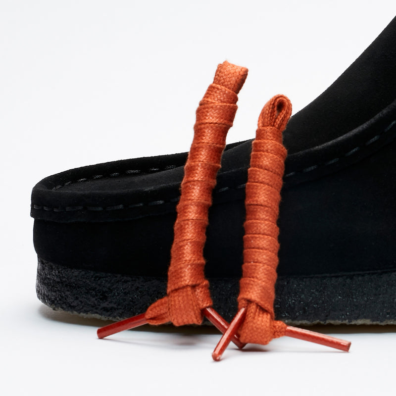 Clarks Wallabee in black suede with a structured moccasin design and signature crepe sole.


