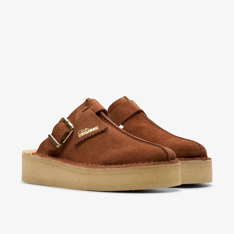 Clarks Originals Trek Wedge Mule in mocha bisque suede with metal buckles, showcasing a central butt seam and natural crepe rubber soles