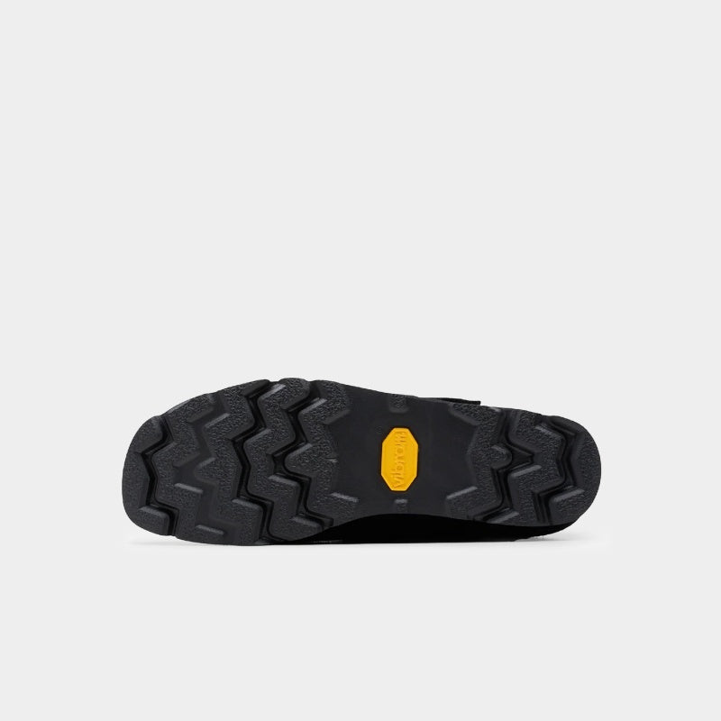 Clarks x Needles Wallabee boot featuring suede upper, debossed butterfly detail, and metal peace sign buckle on adjustable strap.
