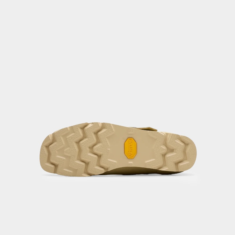 Clarks x Needles Wallabee boot featuring suede upper, debossed butterfly detail, and metal peace sign buckle on adjustable strap.