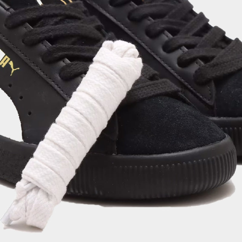 Iconic PUMA Suede by atmos, featuring premium black and white design, blending classic style with modern aesthetics.