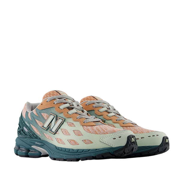 New Balance 1906W sneaker with a knit upper, webbed synthetic overlays, and advanced cushioning technology for ultimate comfort and style.