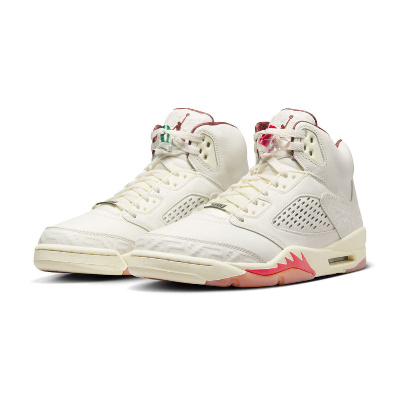 Exclusive AJ5 sneakers celebrating Mexico's heritage, featuring laser-cut leather, embossed patterns, asymmetrical midsole flames, off-white leather, and red and green lace locks, with a "VIVA" dubrae.


