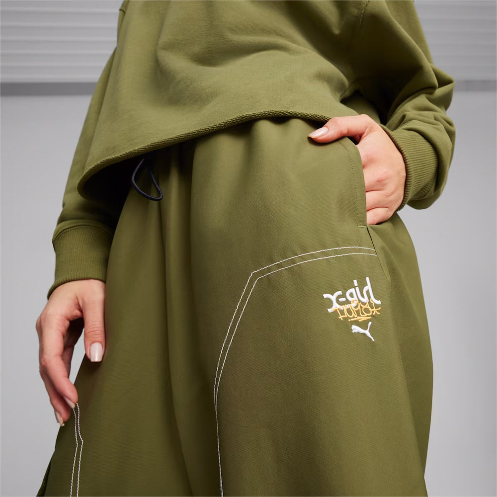Front view of PUMA x X-GIRL Cargo Pants WV in black with utility pockets and co-branded detailing.