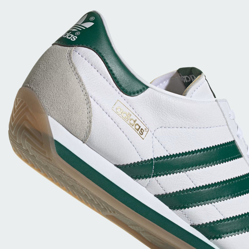 Adidas Gazelle sneakers in suede with three-layered design, serrated 3-Stripes, and metallic-gold "Gazelle" emblem.