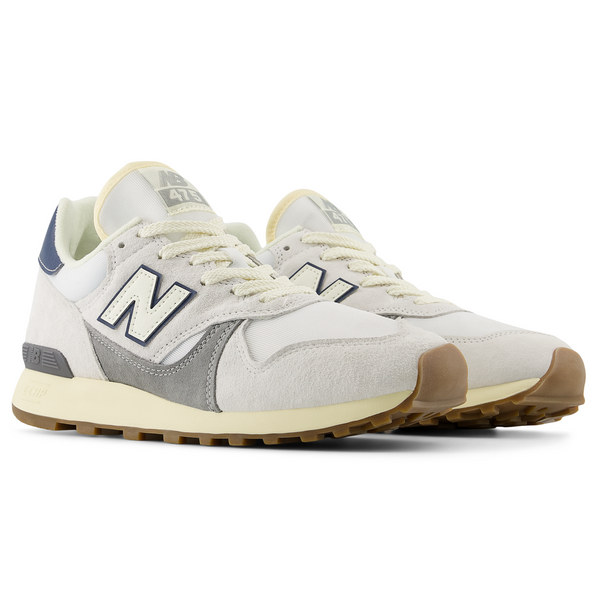 New Balance 475 sneakers with a suede and mesh upper, C-CAP cushioned midsole, and reflective details for enhanced comfort and visibility.