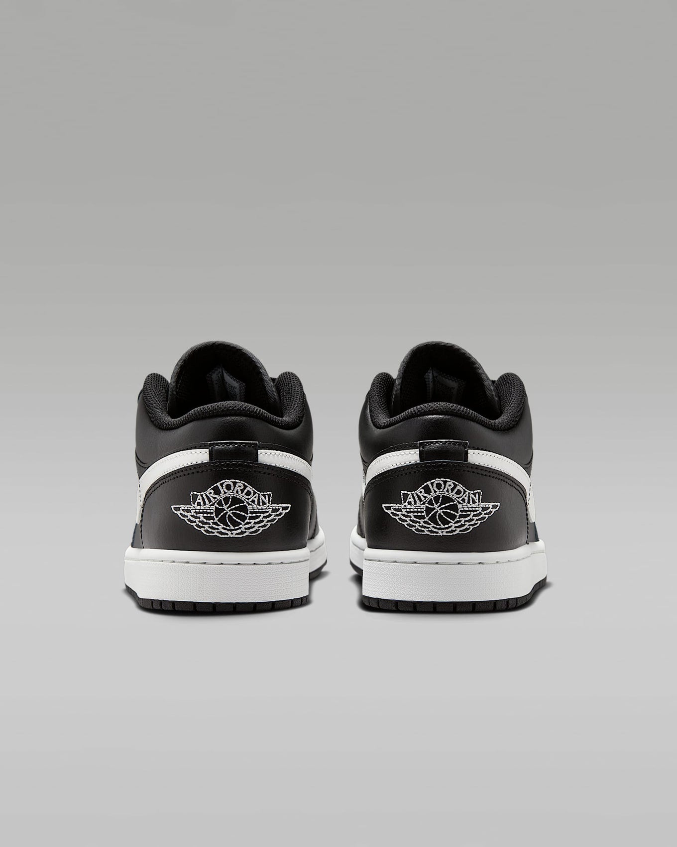 Air Jordan 1 Low sneakers in classic colorway, side profile view.