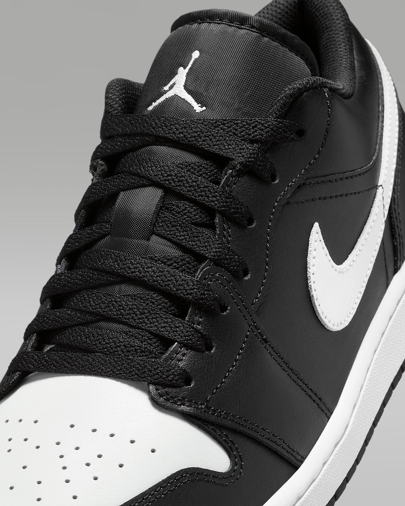 Air Jordan 1 Low sneakers in classic colorway, side profile view.