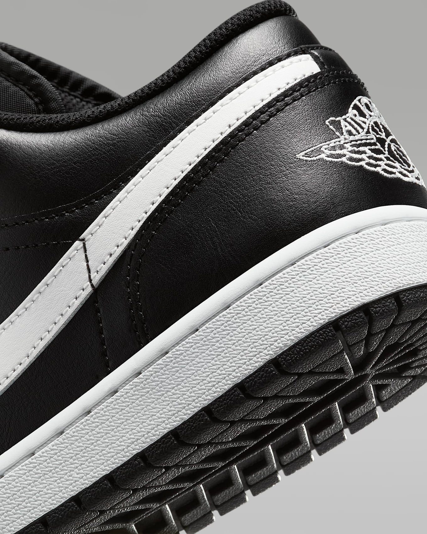Air Jordan 1 Low sneakers in classic colorway, side profile view.