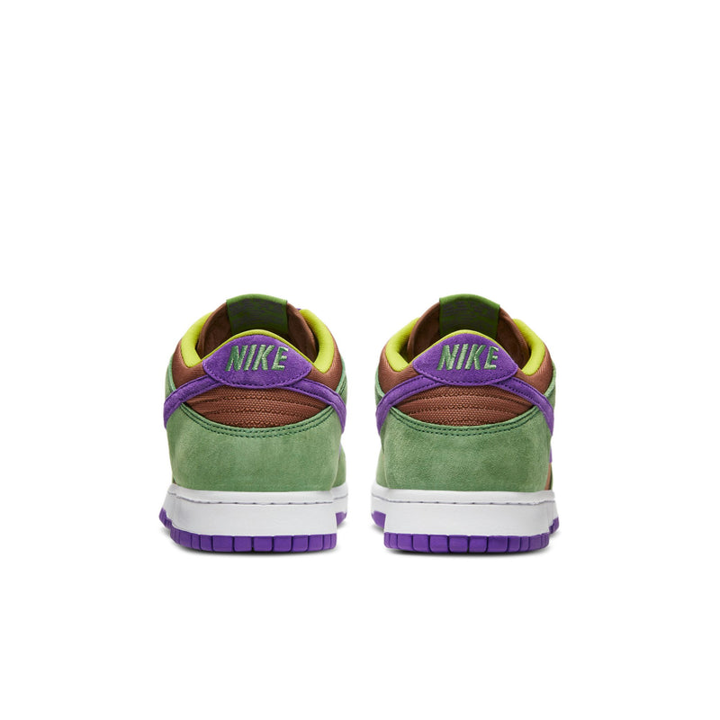 Close-up of the Dunk Low 'Veneer' sneaker featuring a suede upper in green, purple, and brown hues. 