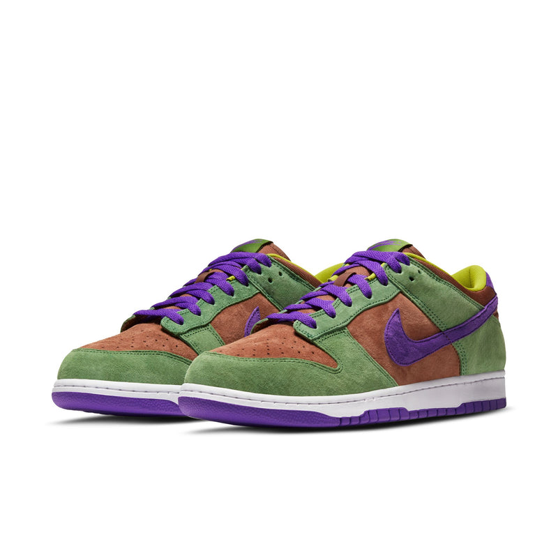 Close-up of the Dunk Low 'Veneer' sneaker featuring a suede upper in green, purple, and brown hues. 