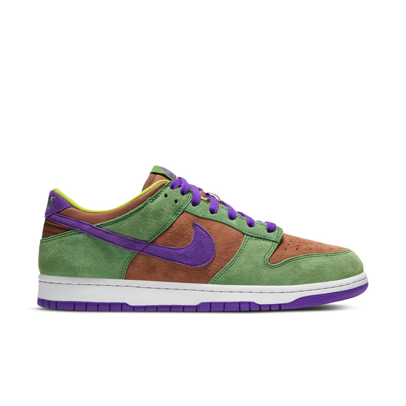 Close-up of the Dunk Low 'Veneer' sneaker featuring a suede upper in green, purple, and brown hues. 