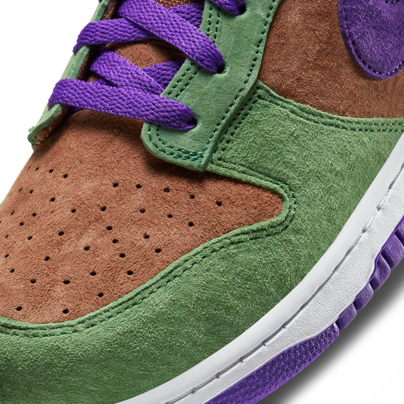 Close-up of the Dunk Low 'Veneer' sneaker featuring a suede upper in green, purple, and brown hues. 