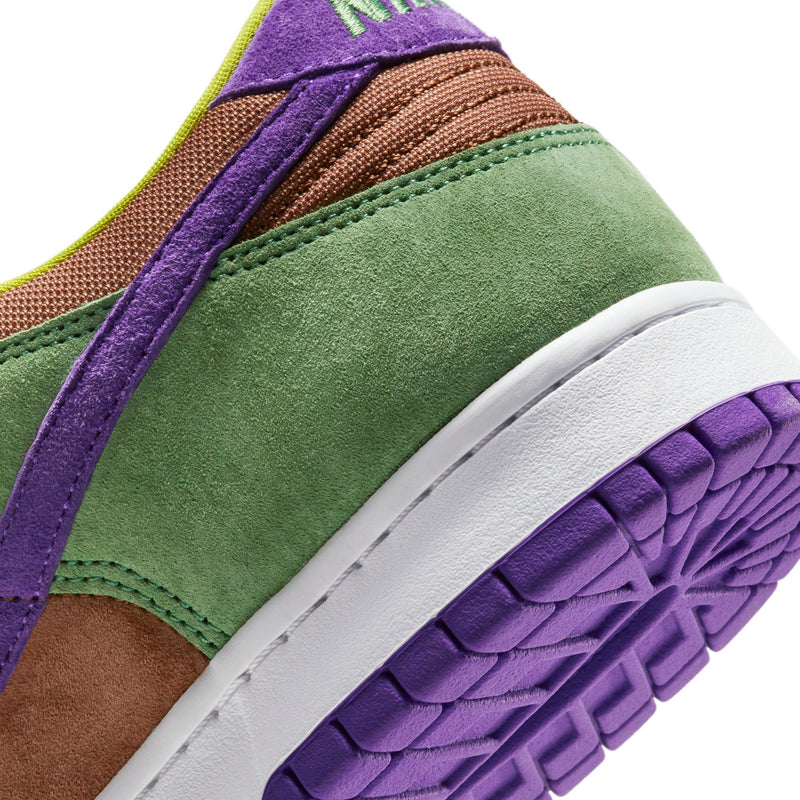 Close-up of the Dunk Low 'Veneer' sneaker featuring a suede upper in green, purple, and brown hues. 