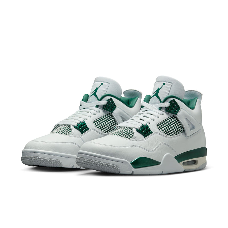 The Air Jordan 4 sneakers in white leather with Oxidised Green accents, featuring metallic lustre on the eyelets, midsole, and branding.