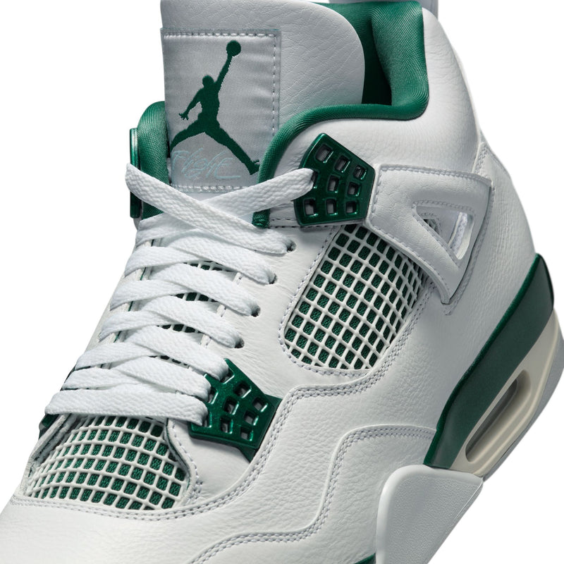 The Air Jordan 4 sneakers in white leather with Oxidised Green accents, featuring metallic lustre on the eyelets, midsole, and branding.