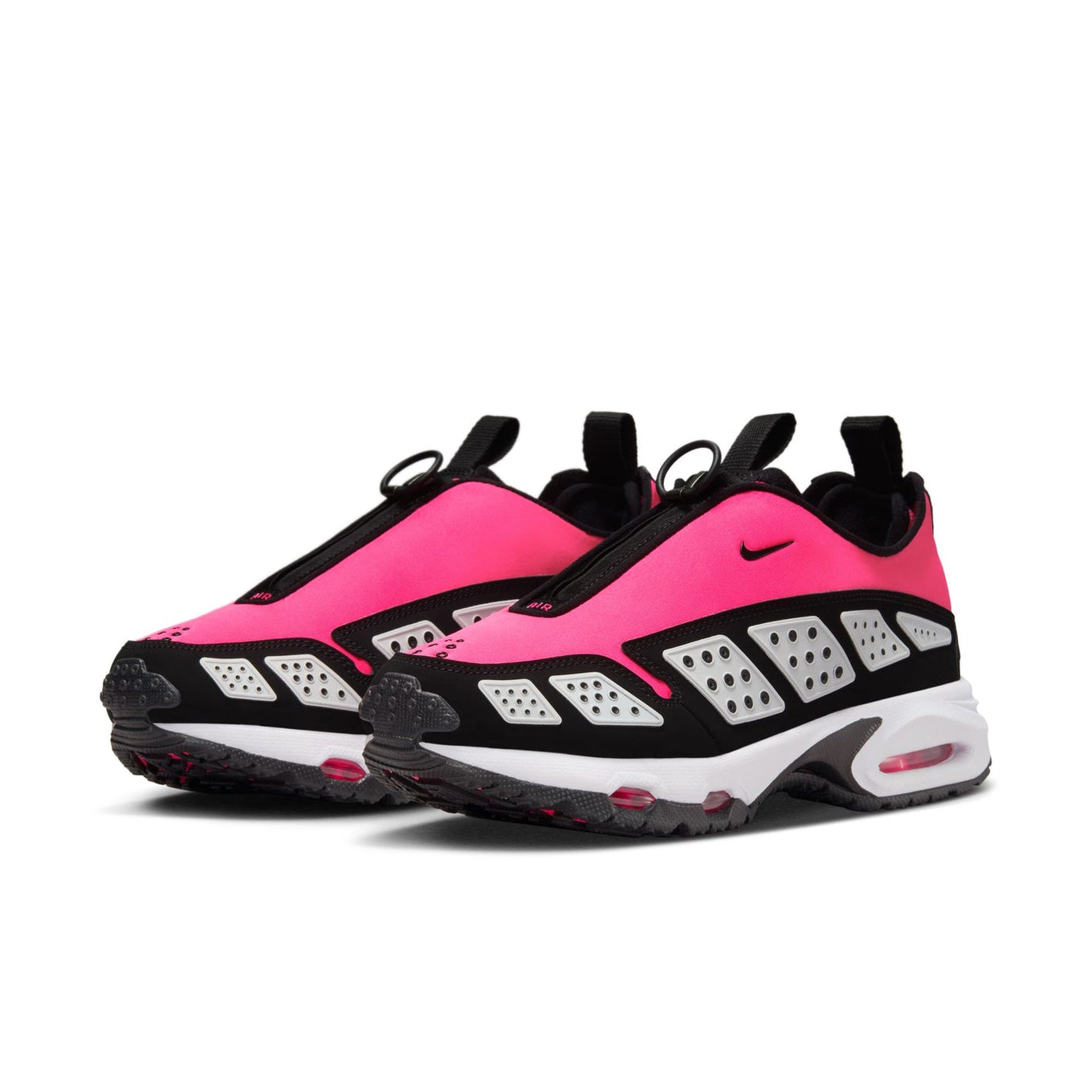 Air Max SNDR sneaker featuring a bold color scheme with black overlays, Hyper Pink shroud, and reflective white panels, equipped with Max Air and Nike Air cushioning. Unzipped shroud reveals "6453," referencing Nike's global office numbers.



