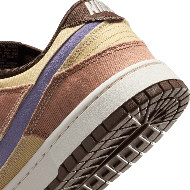 Dunk Low sneaker with iconic color blocking, corduroy layers, and plush padding for comfort and style.