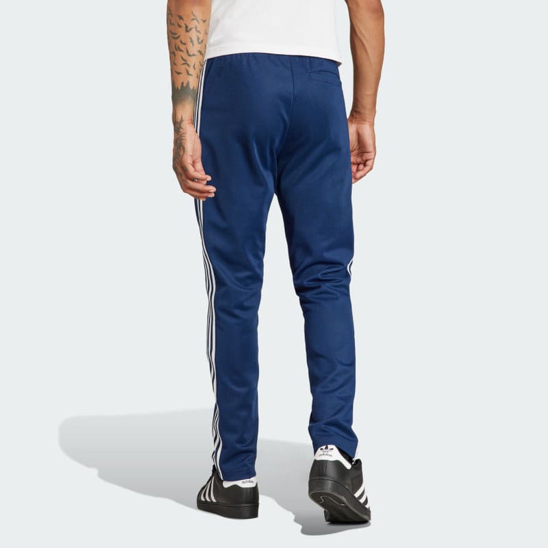 adidas Adicolor Beckenbauer Track Pants with embroidered Trefoil and 3-Stripes detailing, crafted from soft cotton blend, emphasizing comfort and sustainability.