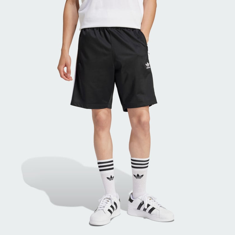 adidas Heritage Shorts made from lightweight tricot fabric, featuring side pockets and an elastic waist with drawcord for a customized fit.