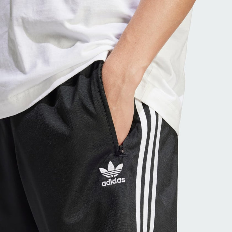 adidas Heritage Shorts made from lightweight tricot fabric, featuring side pockets and an elastic waist with drawcord for a customized fit.