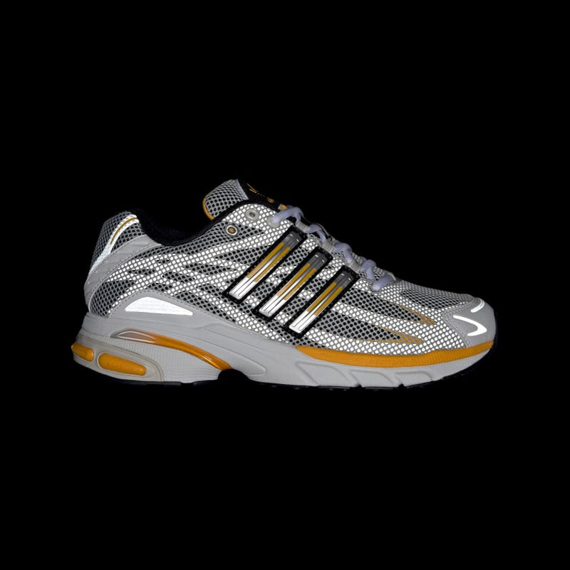 Adidas Adistar Cushion Shoes with breathable mesh upper, Adiprene cushioning, and metallic reflective details, combining retro style with modern comfort.