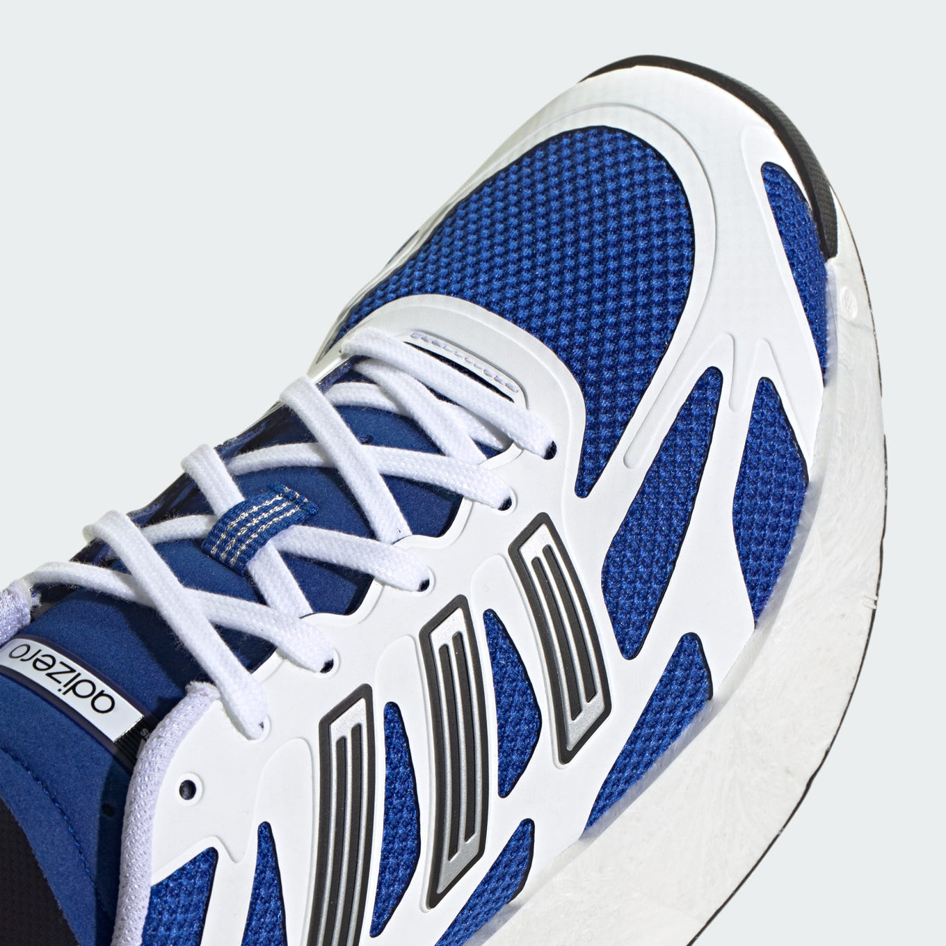 adidas Adizero Aruku sneakers with a curved rocker midsole, Swirlfoam cushioning, and heritage-inspired design details for ultimate comfort and style.