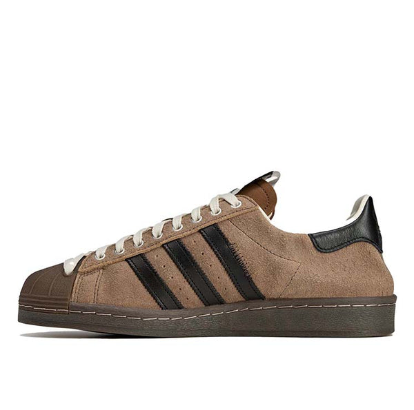 adidas Superstar x Song for the Mute sneakers with a collapsible upper, extended eyelets, and iconic rubber shell toe, blending classic and contemporary design.