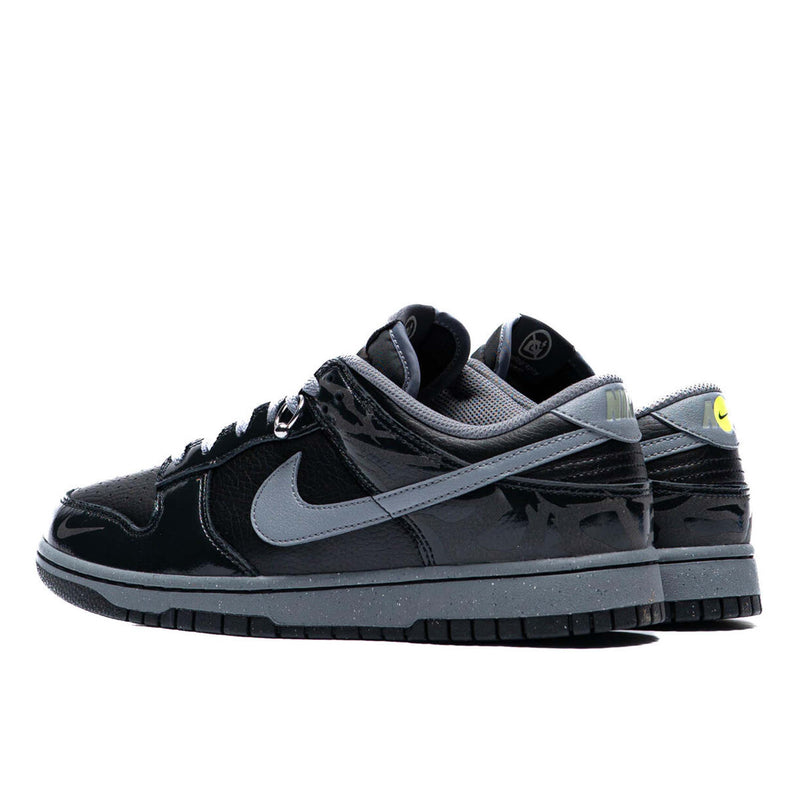 Berlin-inspired Dunk Low sneaker in black and Off-Noir, featuring glossy patent leather accents and reflective tattoo art design on the heel.