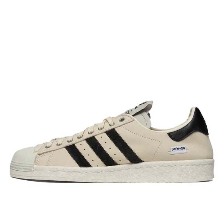 adidas Superstar x Song for the Mute sneakers with a collapsible upper, extended eyelets, and iconic rubber shell toe, blending classic and contemporary design.