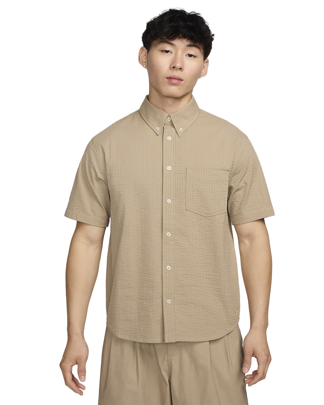 Seersucker fabric with breathable, crinkled texture, ideal for versatile button-up items. Pair with matching shorts for a stylish, comfortable ensemble.