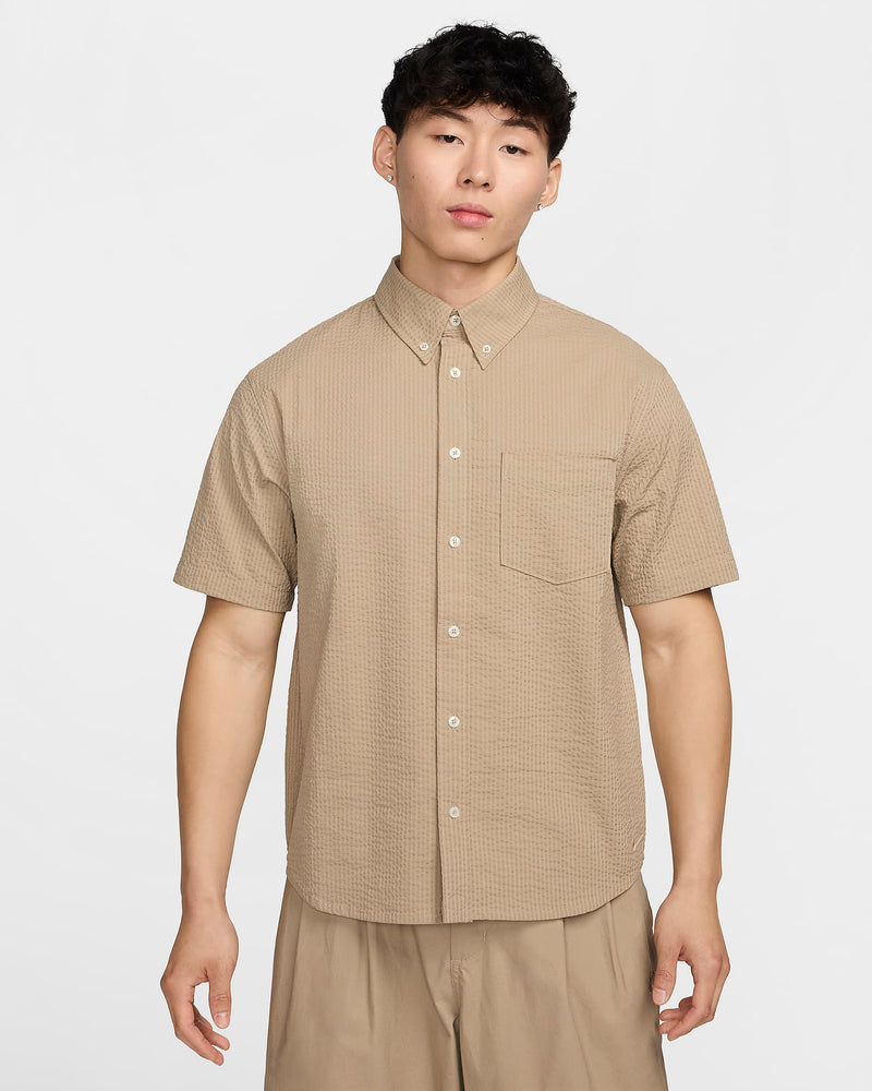 Seersucker fabric with breathable, crinkled texture, ideal for versatile button-up items. Pair with matching shorts for a stylish, comfortable ensemble.