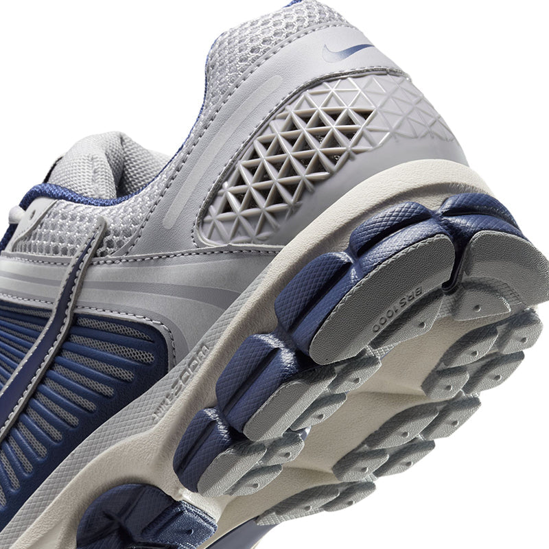 Zoom Vomero 5 with layered textiles, suede accents, Zoom Air cushioning, and breathable design.