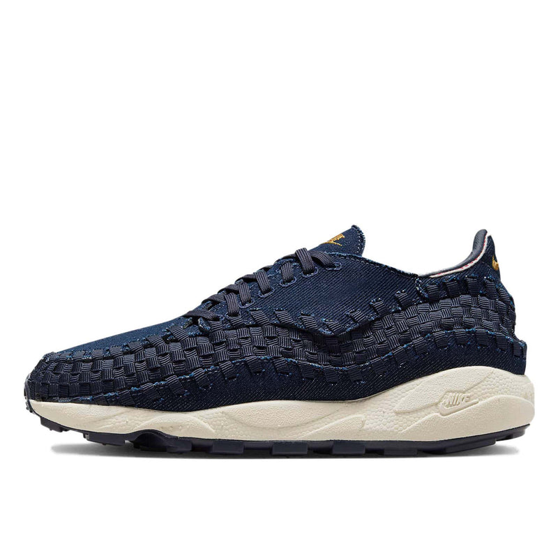 Air Footscape Woven denim sneaker with roomy toe box, lateral lacing, foam midsole, and Nike Air cushioning.