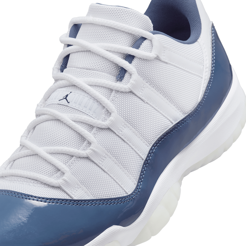 AJ11 sneakers featuring premium leather and lightweight textiles in white, Diffused Blue, and Midnight Navy.