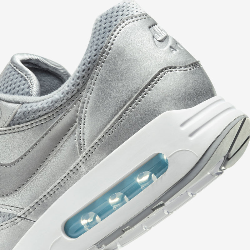 Nike Air Max 1 '86 Big Bubble in Metallic Silver and Cool Grey, featuring a reduced Air window, debossed branding on the tongue and heel, and a sleek, refined design.


