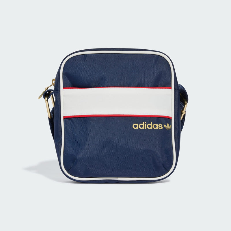 adidas Festival Bag with retro design, contrasting colors, piping details, and gold zippers, featuring a spacious main compartment and hidden front zip pocket.


