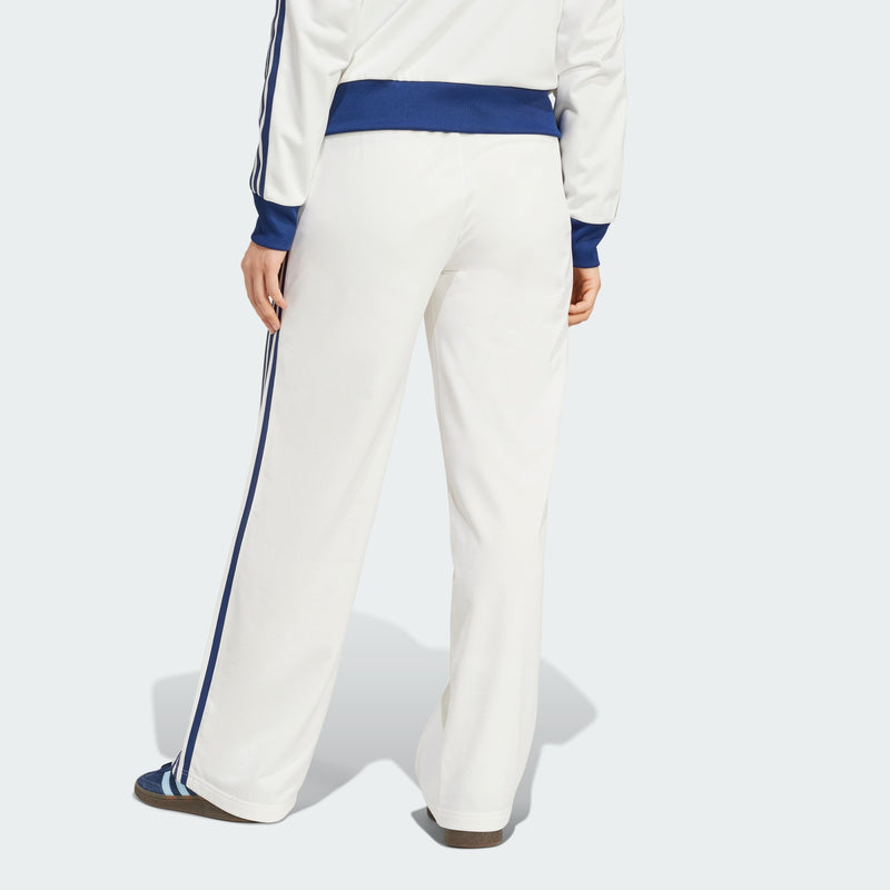 Adidas Firebird track pants featuring classic 3-Stripes, signature tricot sheen, and colors inspired by international competition, embodying a timeless sports style.



