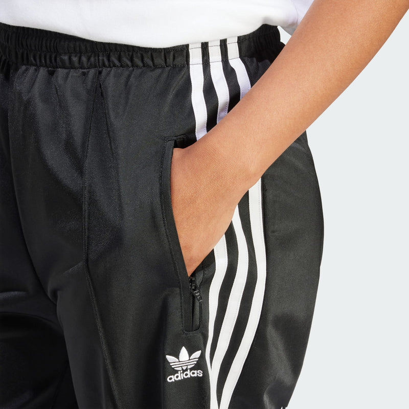 Adidas Originals Firebird track pants with 3-Stripes and Trefoil logo, made from 100% recycled materials.


