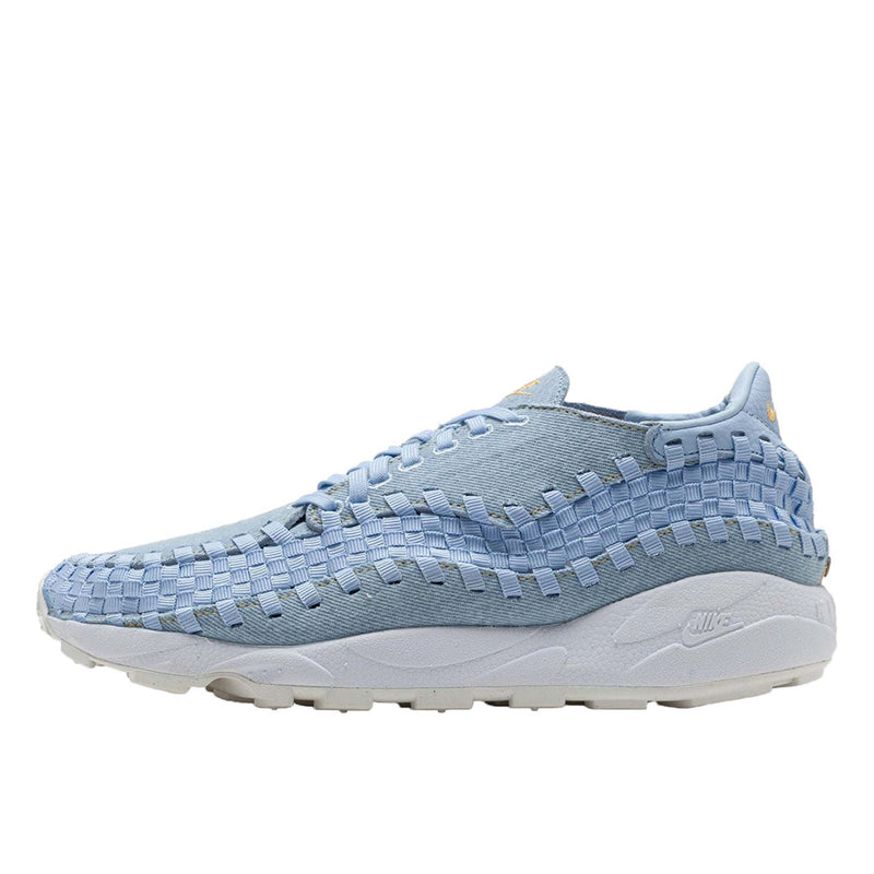 Nike Footscape Woven in monochromatic denim with woven "blue jeans" pattern, rivet detail, and yellow stitching.