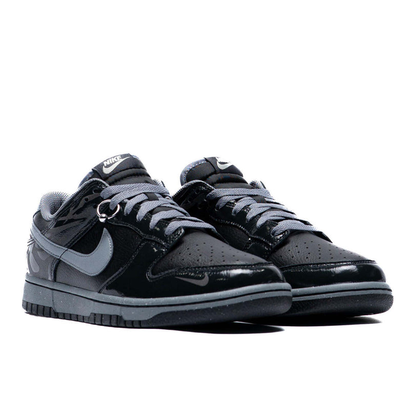 Berlin-inspired Dunk Low sneaker in black and Off-Noir, featuring glossy patent leather accents and reflective tattoo art design on the heel.